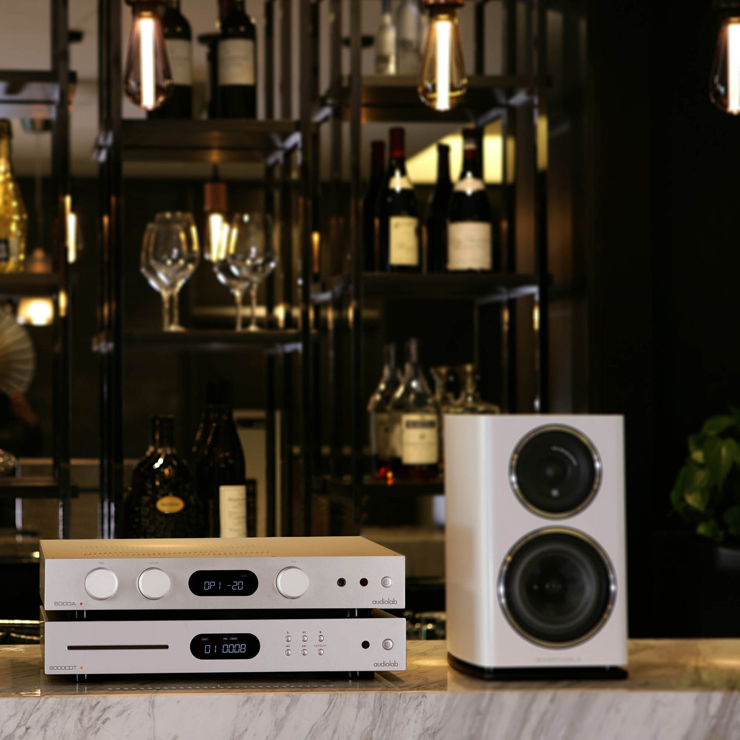 Audiolab 6000A and 6000CDT sitting next to a speaker