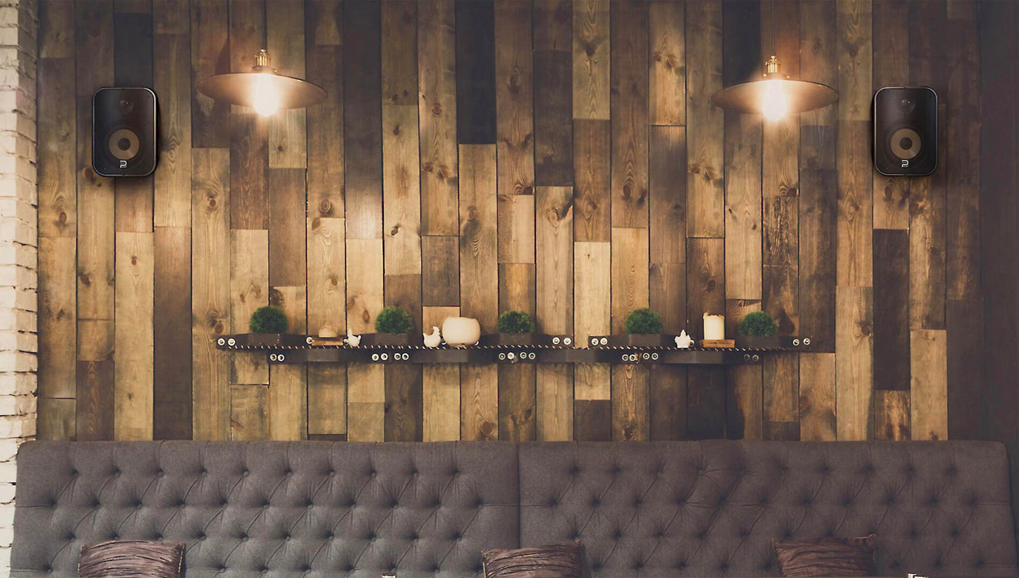 Wooden wall with decorative elements and a gray upholstered bench.