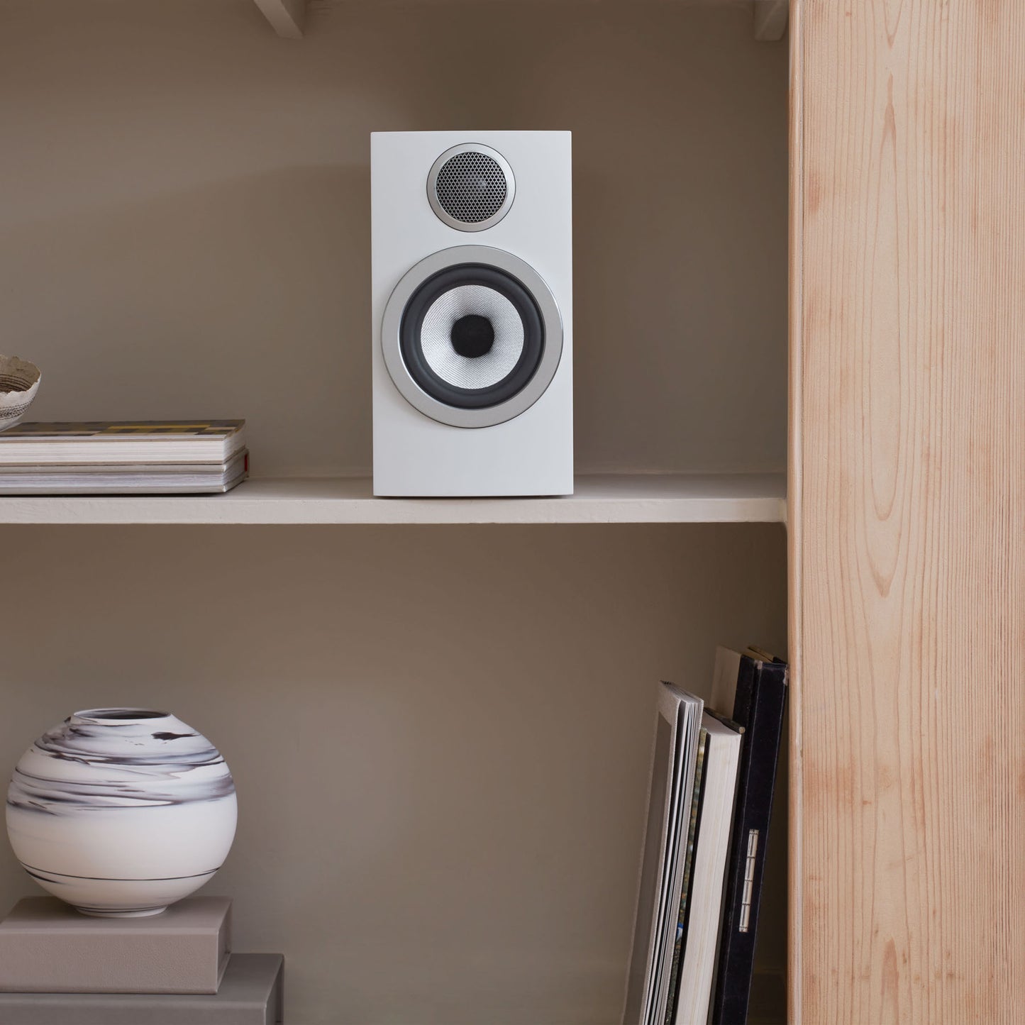 white bowers and wilkins speaker on shelf