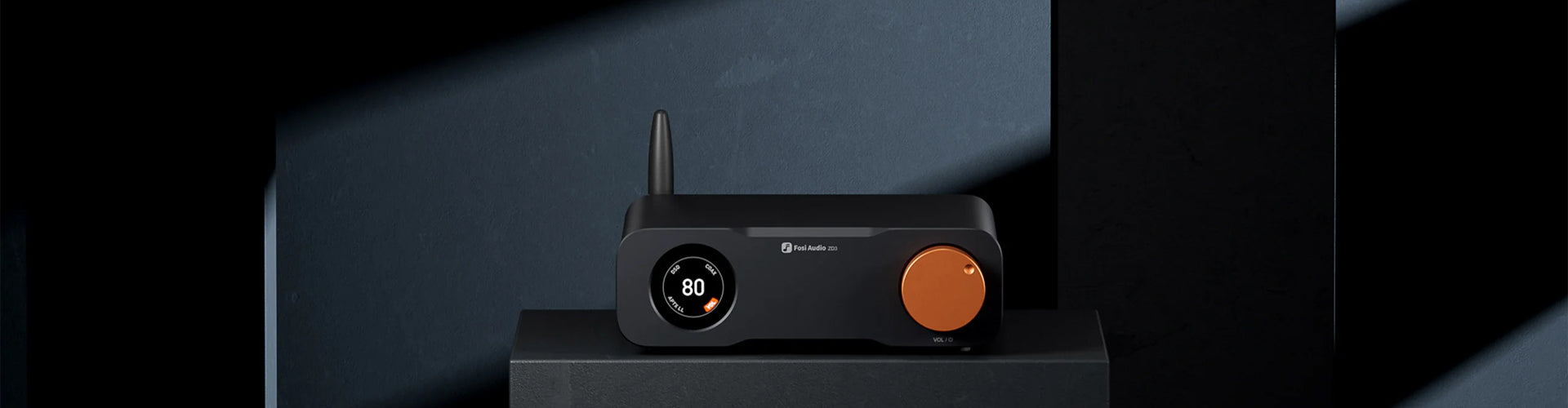 Black electronic device with a copper button on a dark background