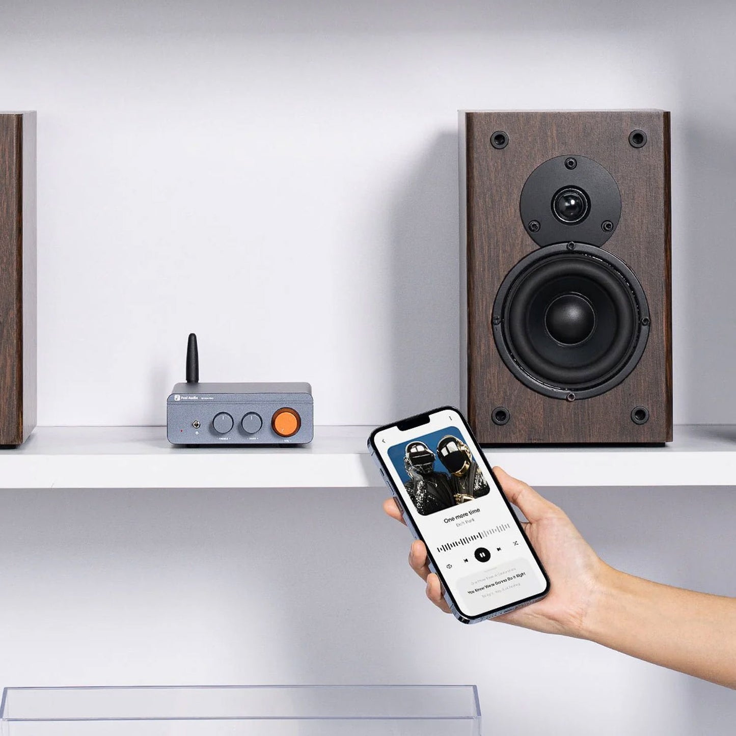 Wooden speakers on a shelf with a smartphone and Fosi Audio BT20A Pro, against a white background
