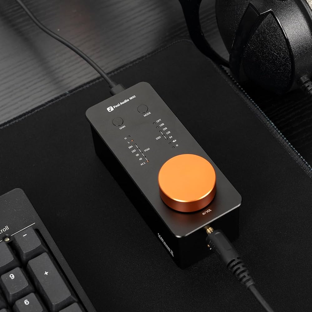 Fosi Audio SK02 Desktop DAC Headphone Amplifier plugged into devices