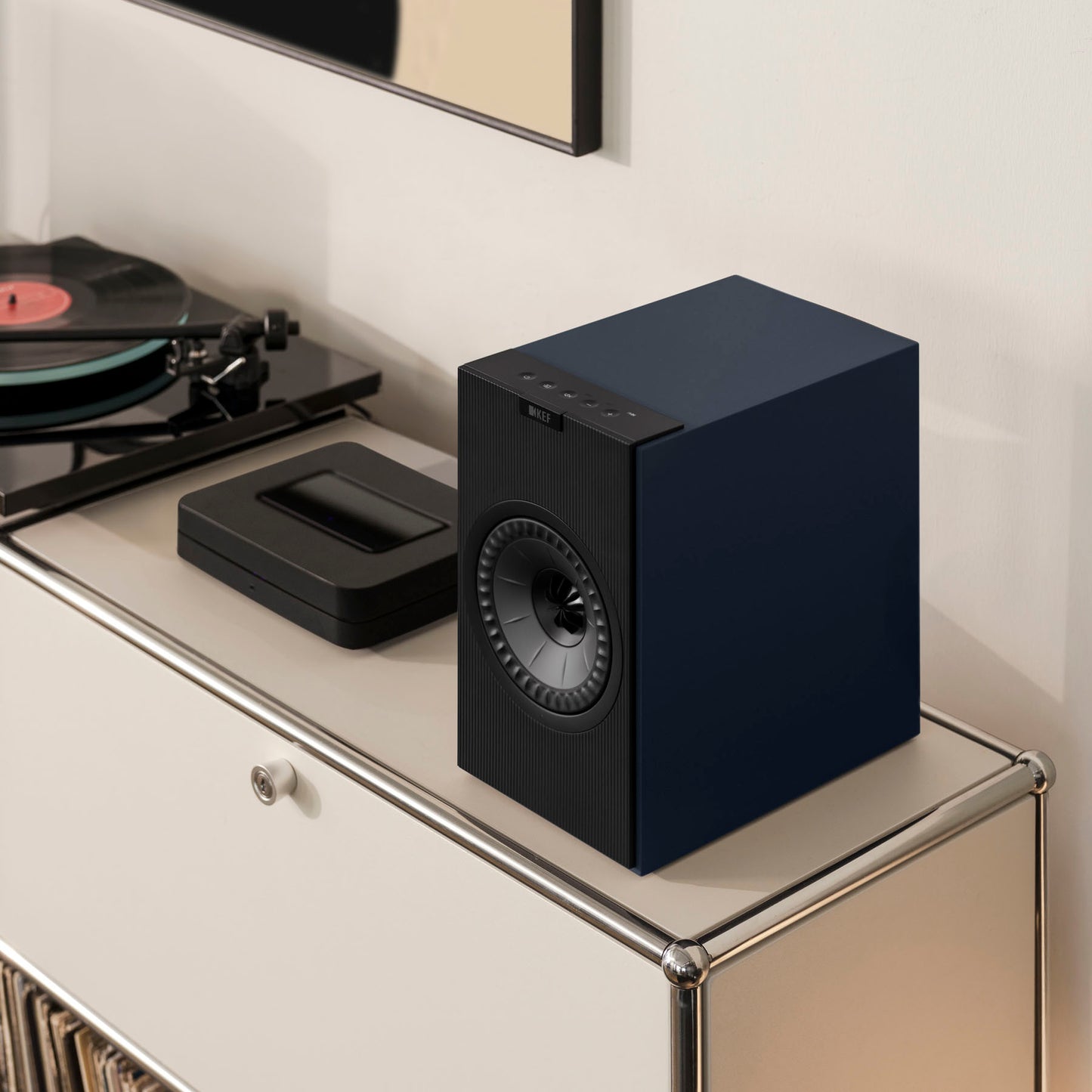 KEF Coda W Speakers in midnight blue on white cabinet with black turntable