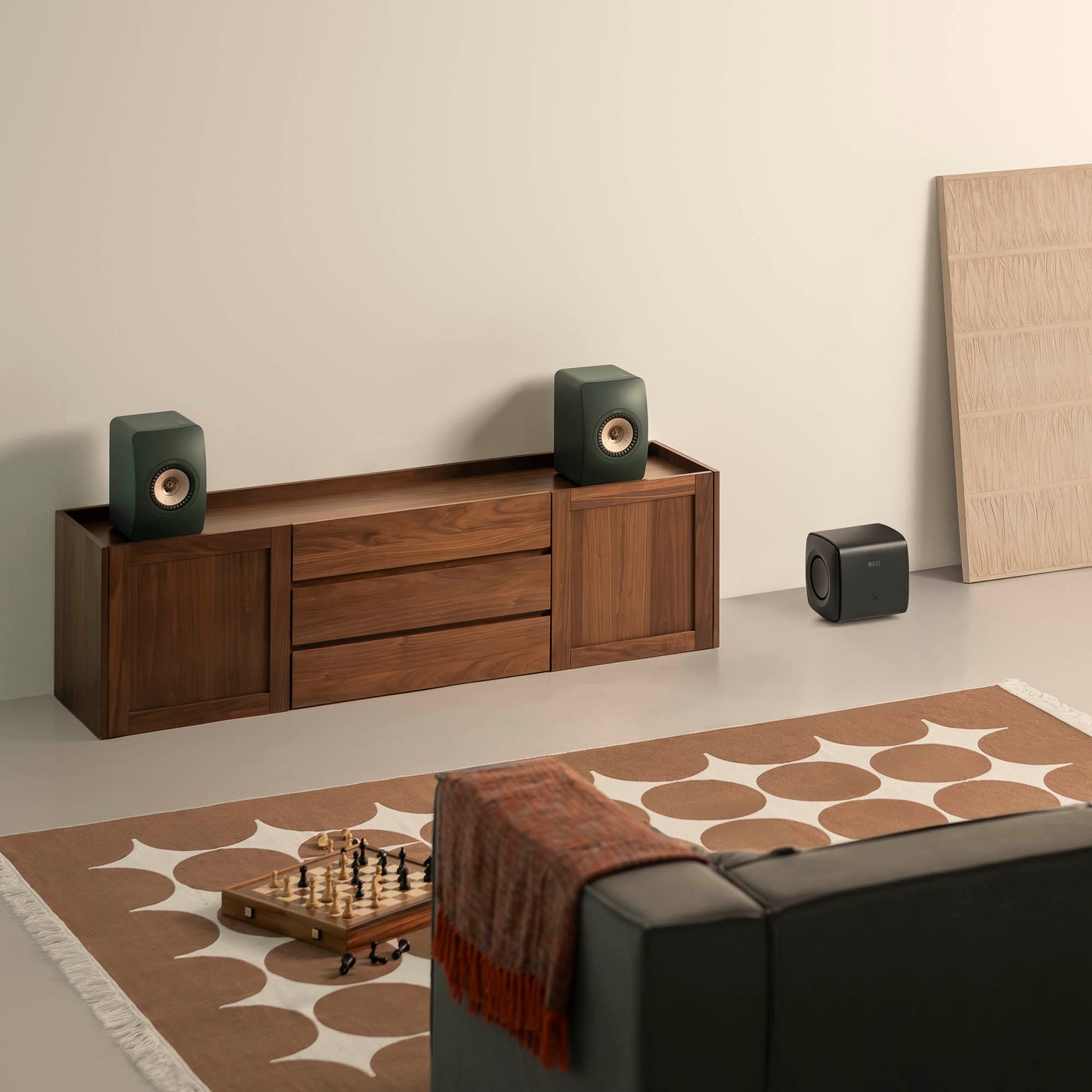 Wooden entertainment console with speakers in a living room setting