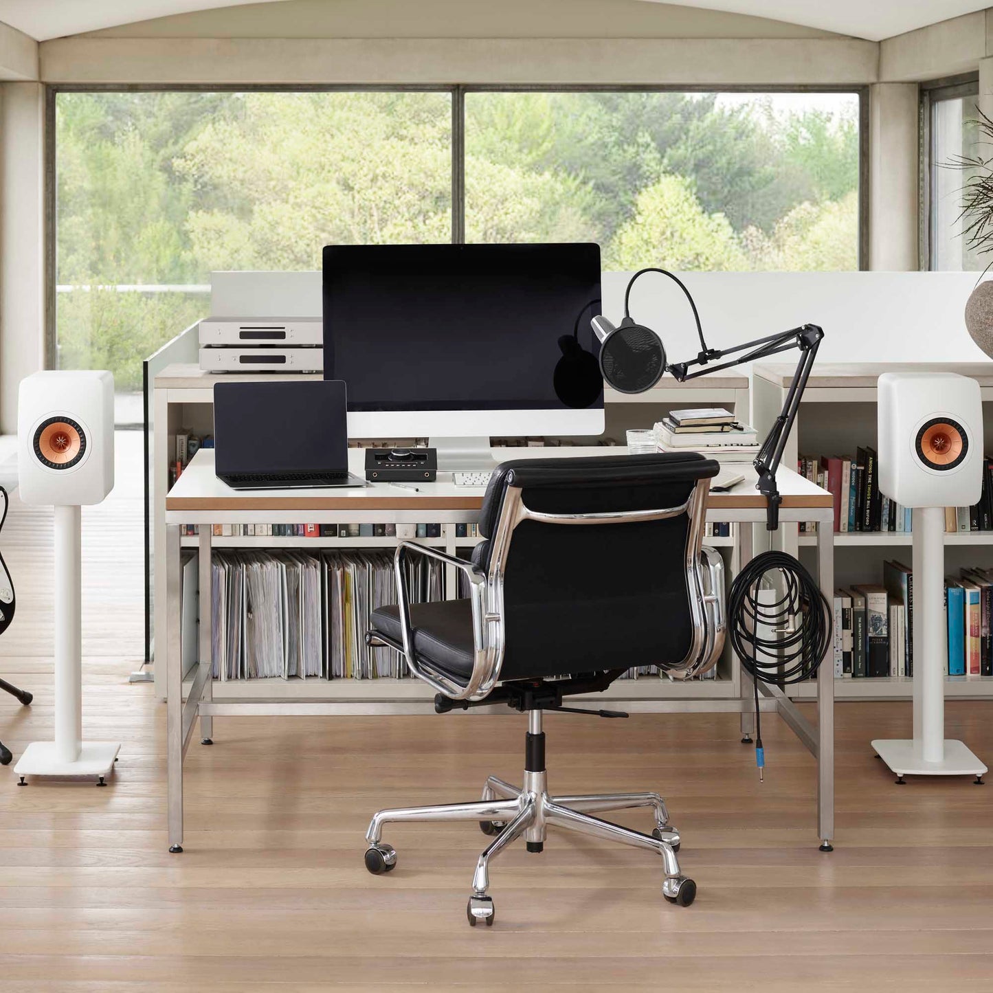 Pair of Pair of KEF LS50 Meta Bookshelf Speakers in White finish on stands next to computer desk