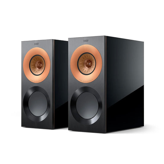 A pair of black KEF Reference 1 Meta bookshelf speakers with copper-colored tweeter frames.