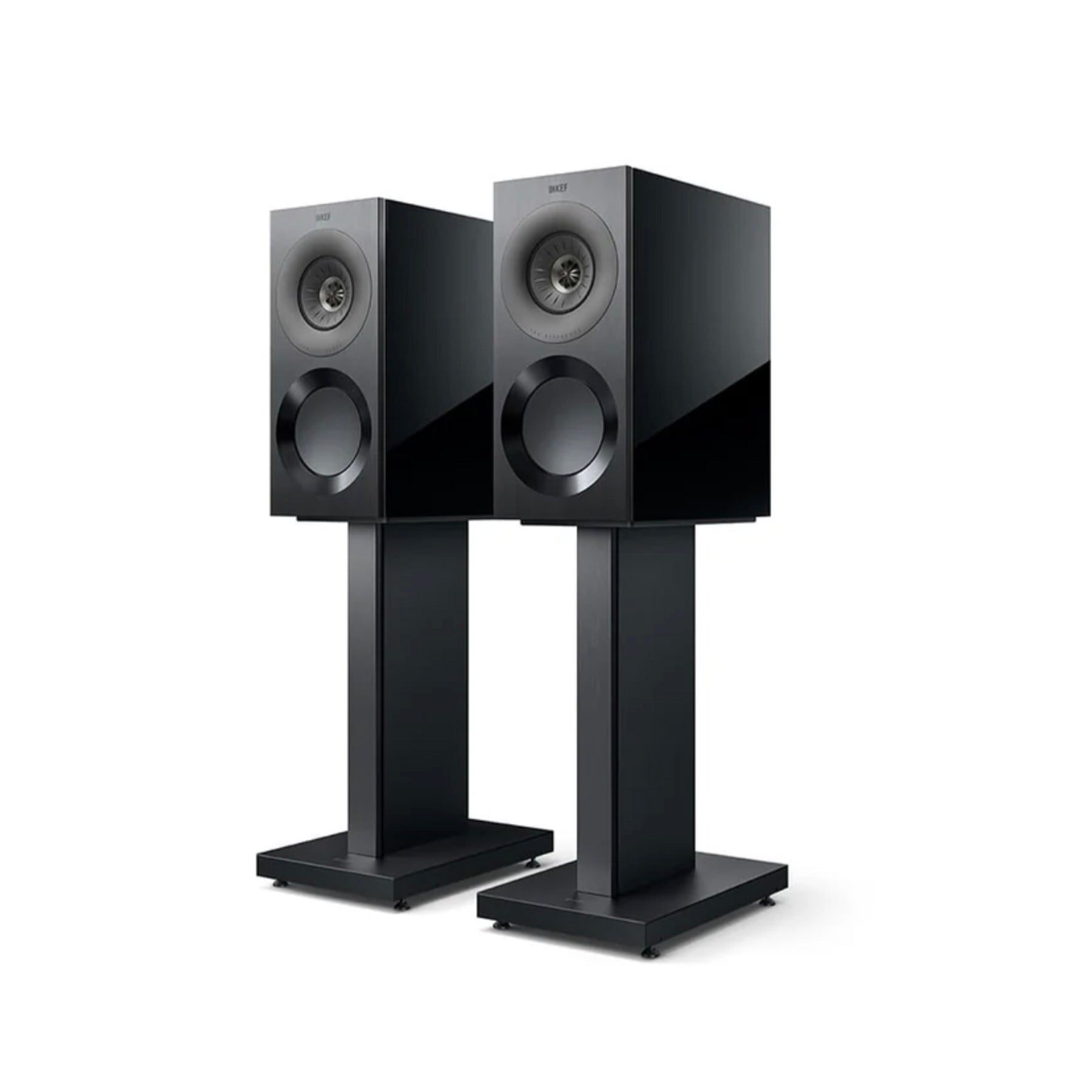 Pair of black KEF Reference 1 speakers on stands against a white background