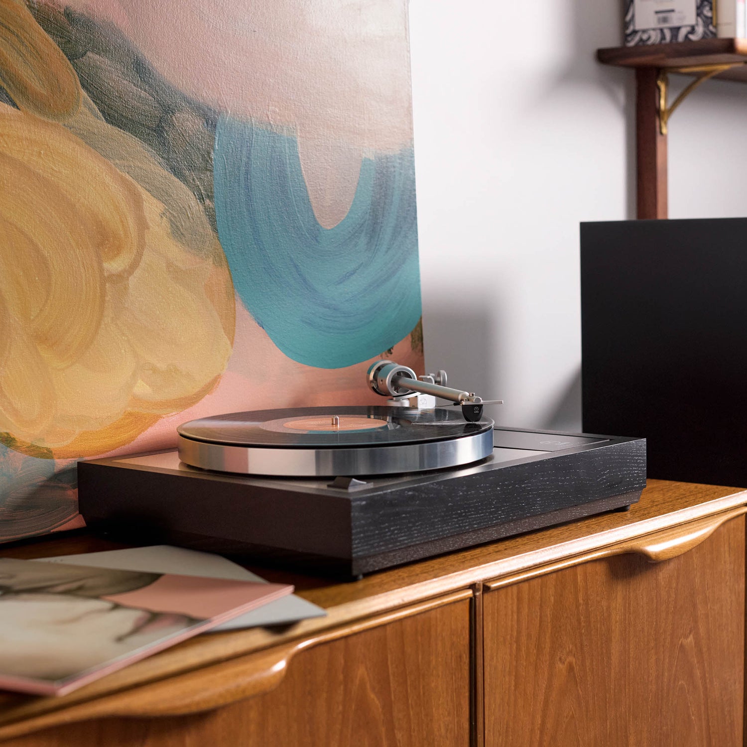Linn LP12 on cabinet with artwork behind it