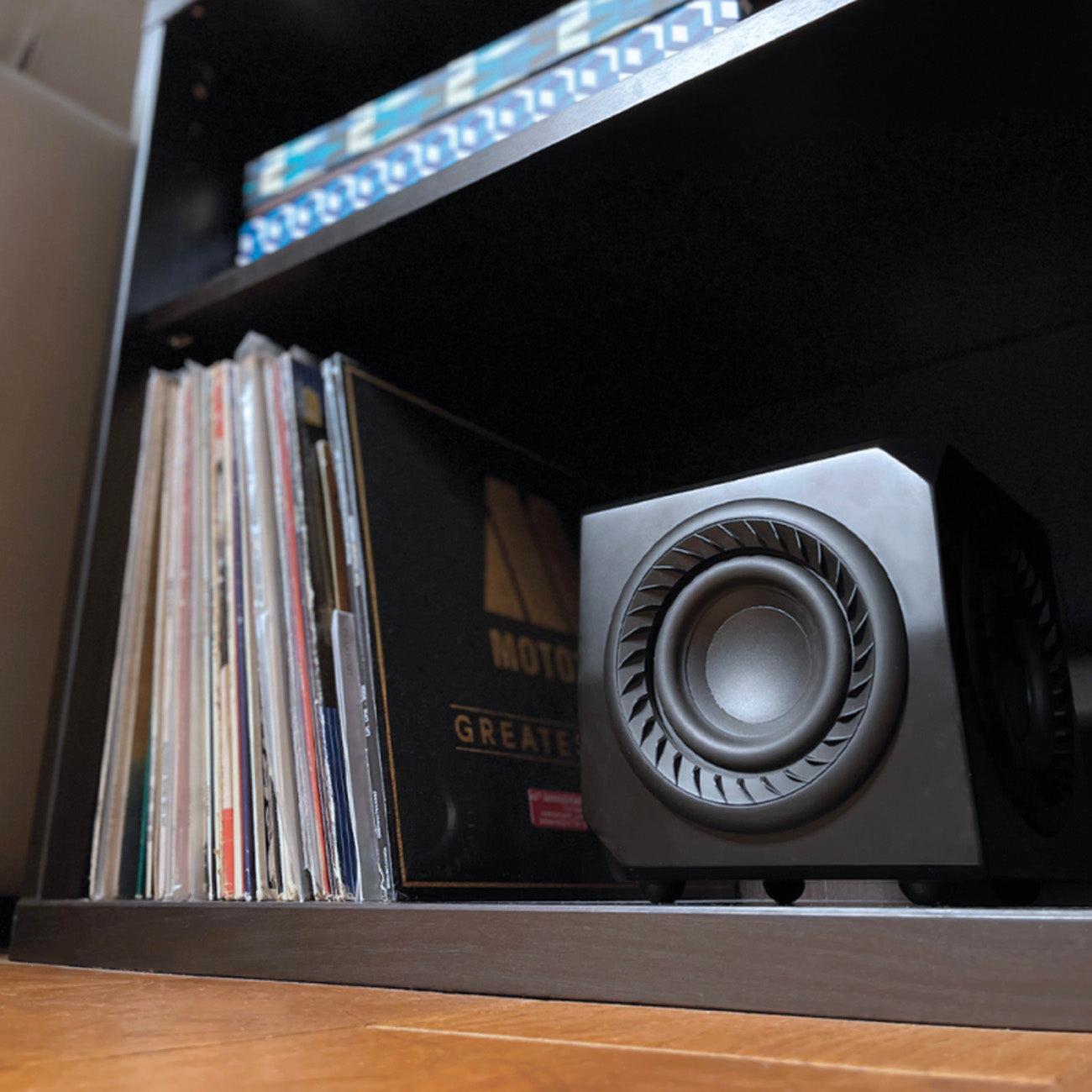 Lithe Audio Wireless Micro Subwoofer on shelf with records