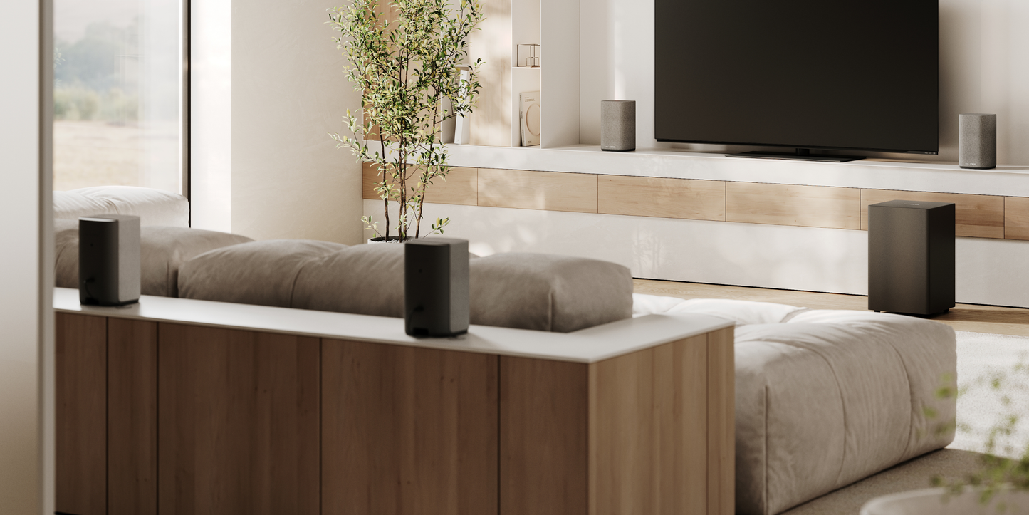 Modern living room with a TV, speakers, and decorative elements.