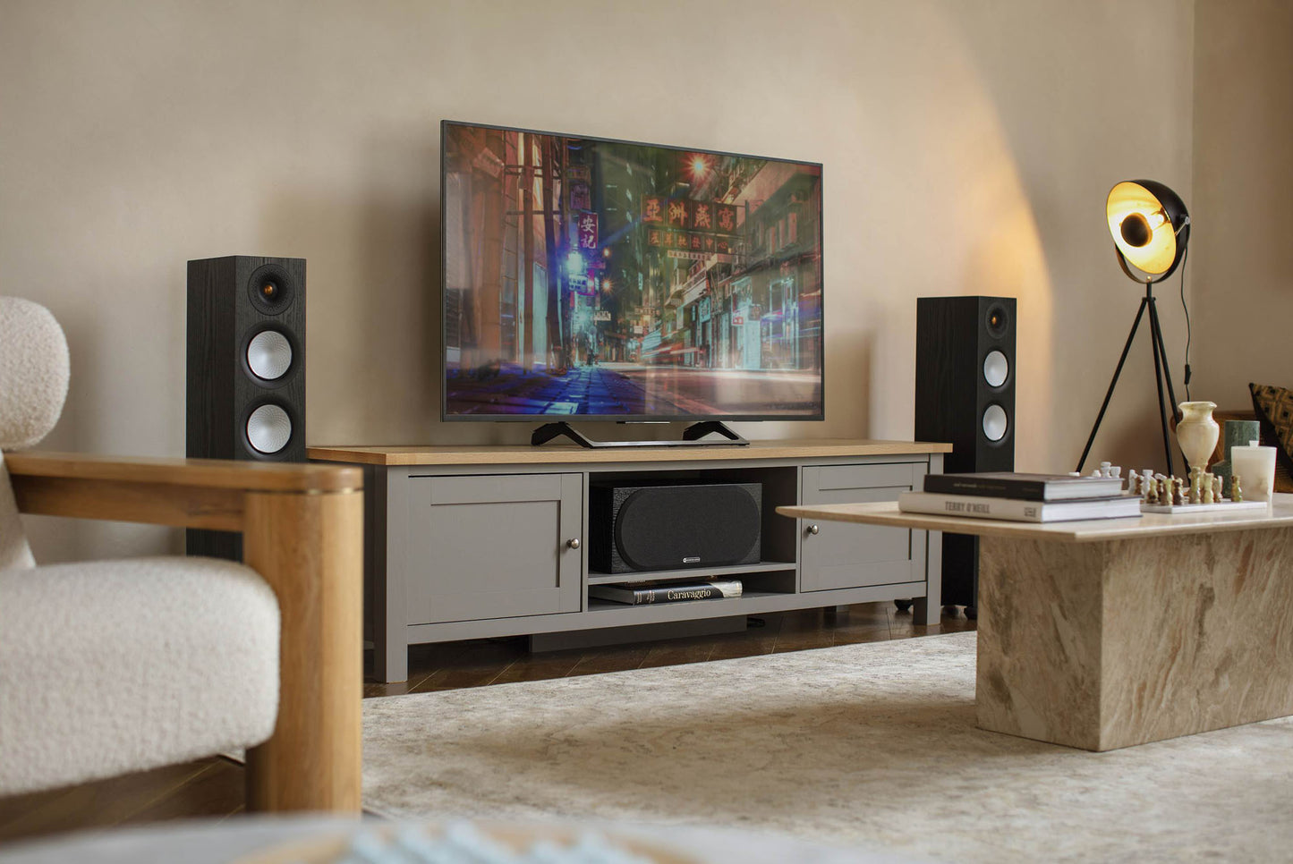 Living room setup with a TV, speakers, and decorative items.