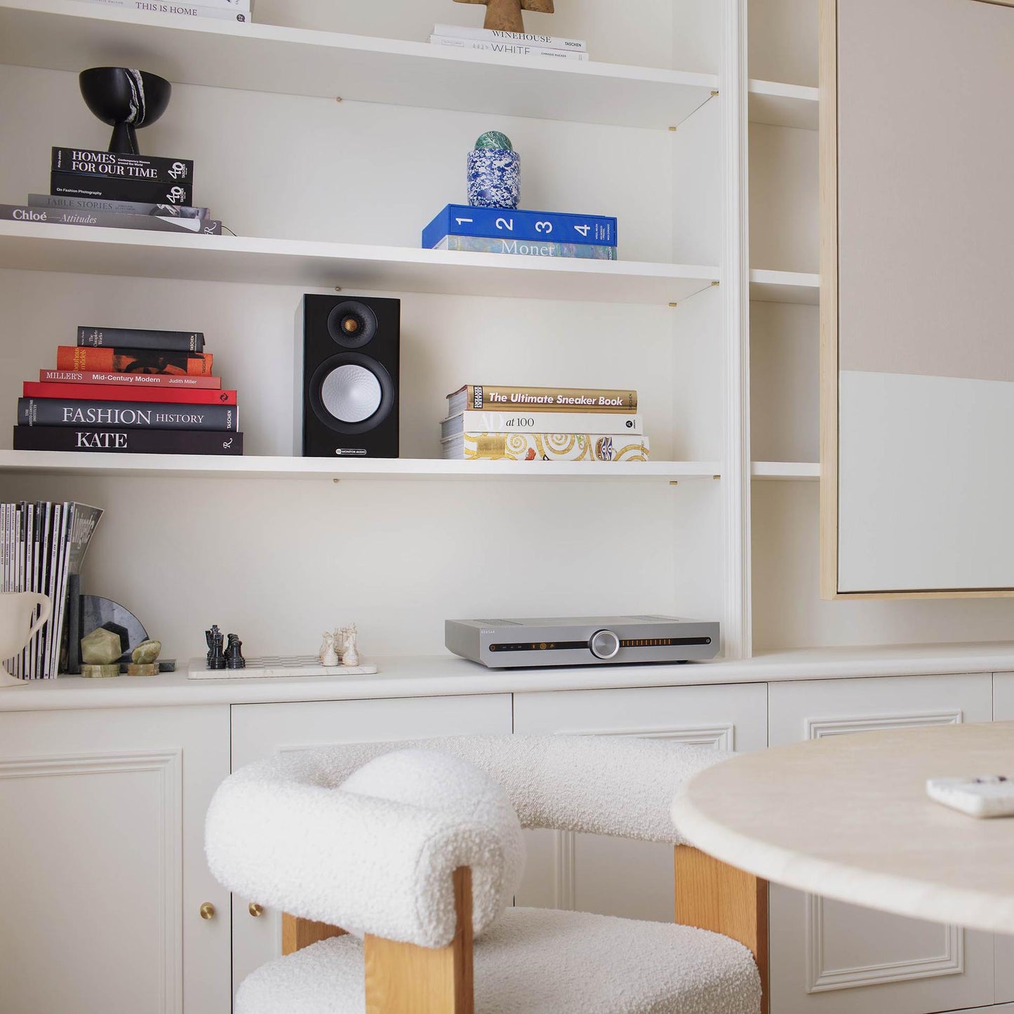 Home office with bookshelf, chair, and desk.