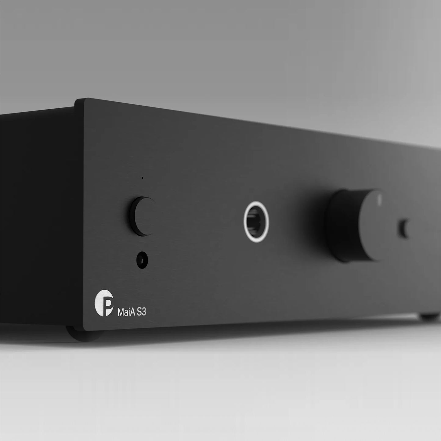 Black audio amplifier with two knobs and a label on a gray background