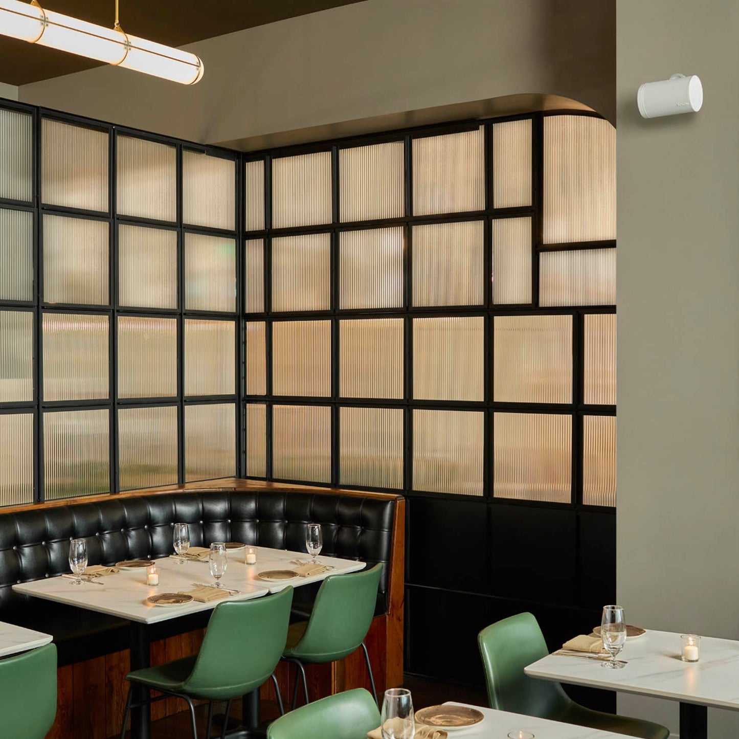 White Sonos Era 100 Pro wireless speakers - in a restaurant
