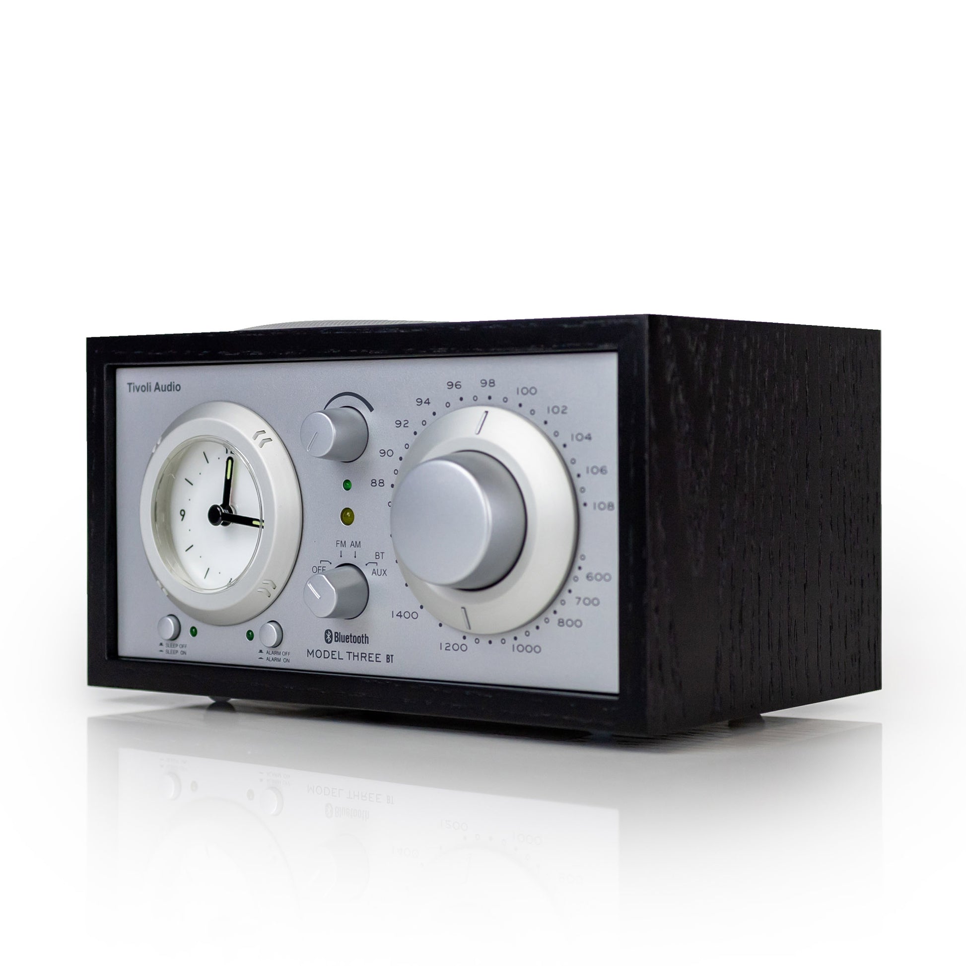 Black radio with clock face on a white background