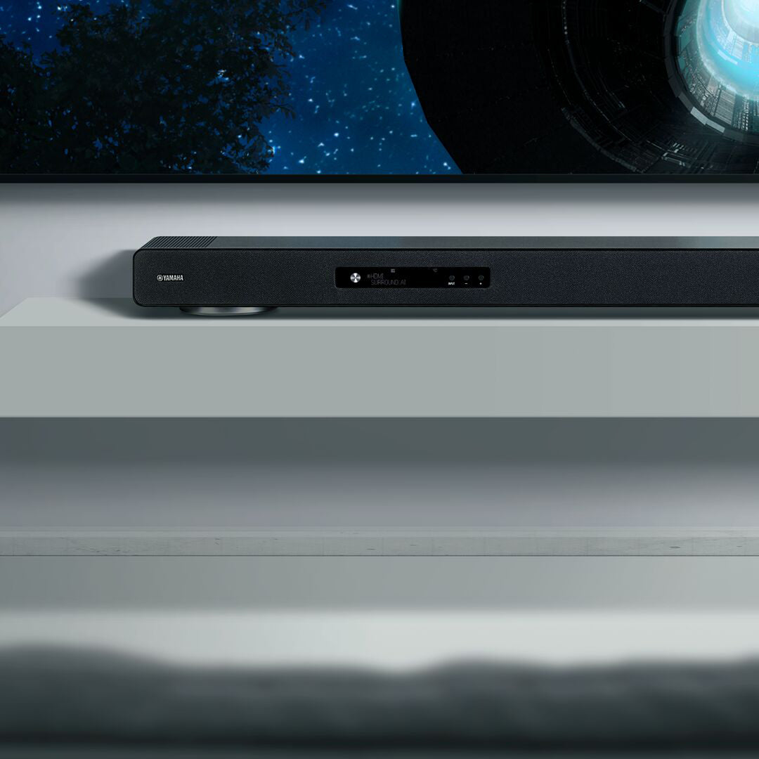 Soundbar on a shelf with a television in the background