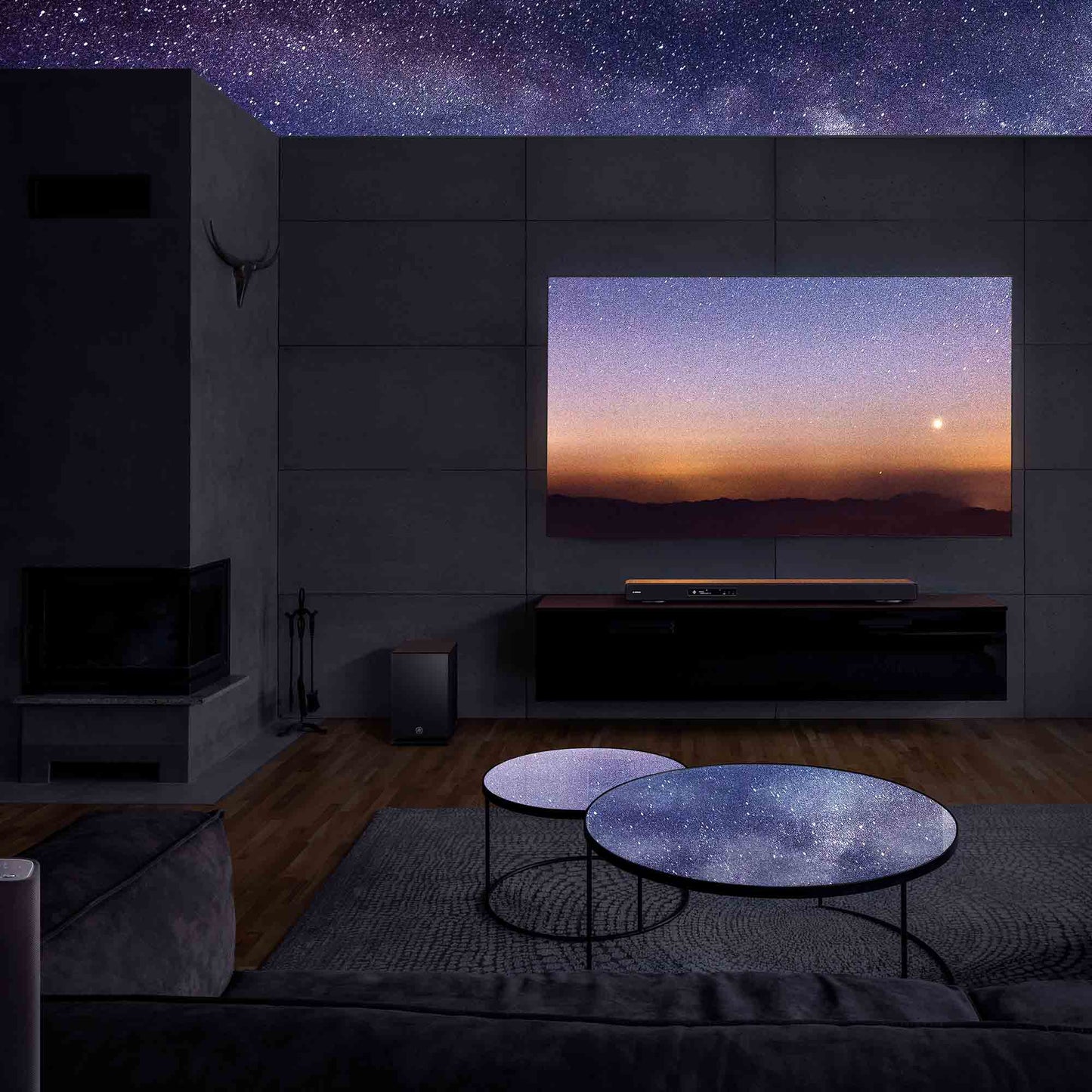 Modern living room with a large TV displaying a starry sky scene.