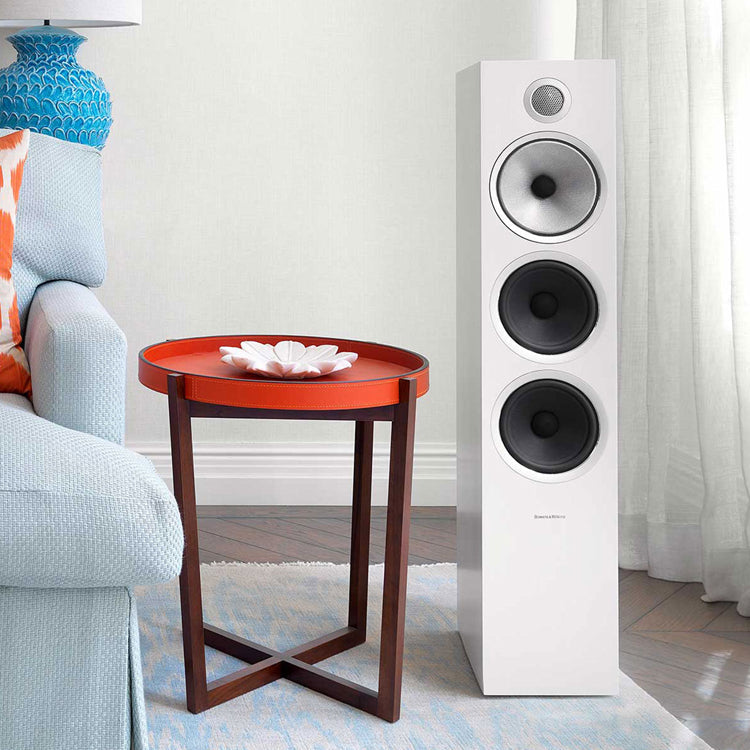 white floorstanding speaker next to coffee table