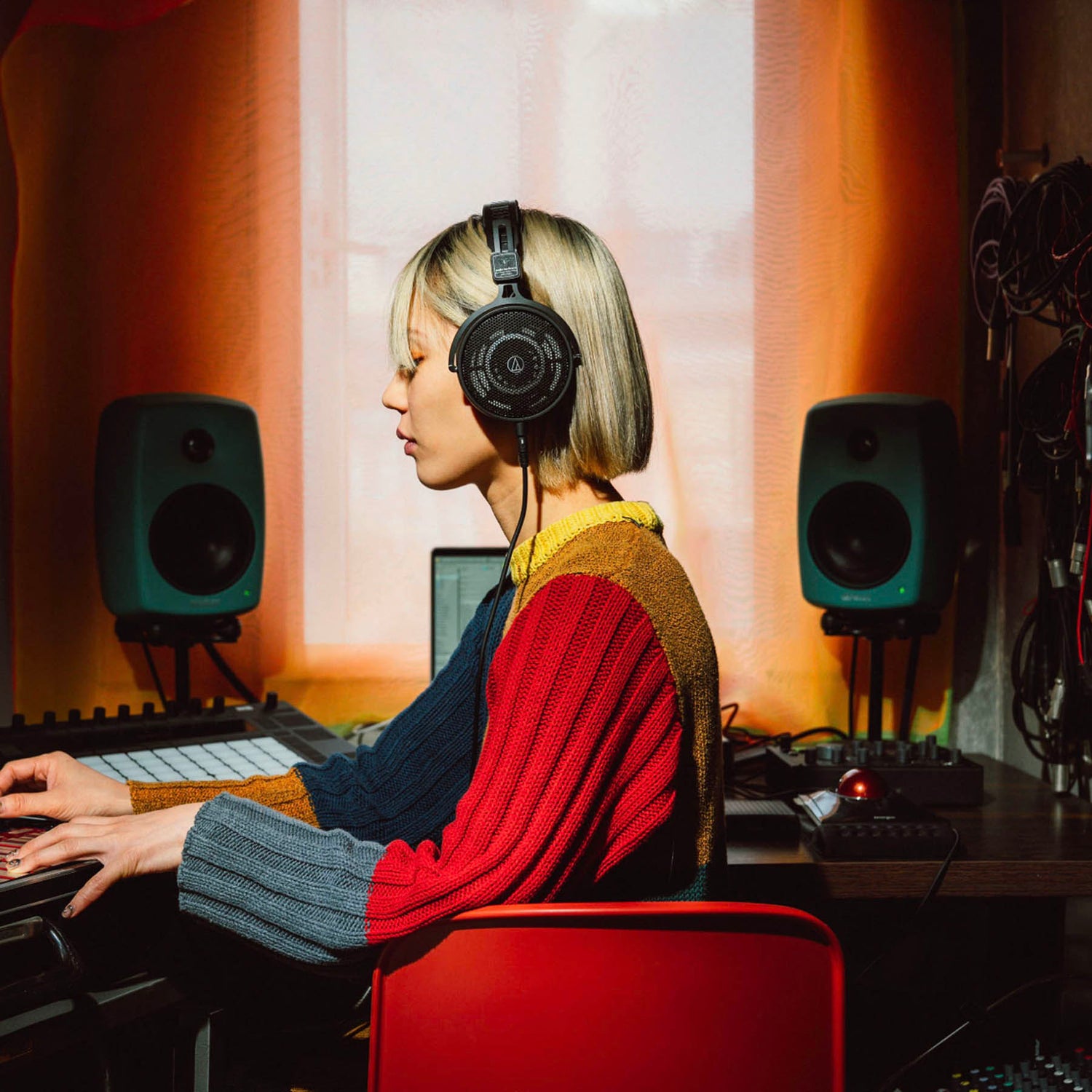 lady wearing over ear headphones in studio
