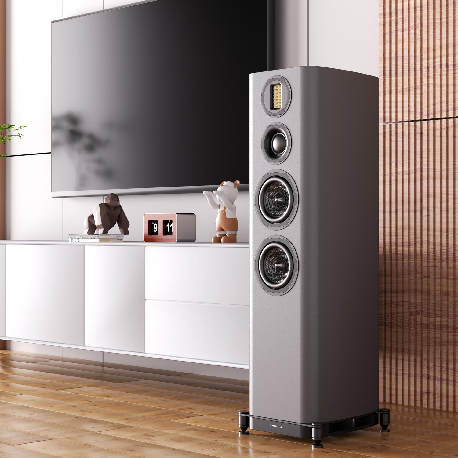 Floorstanding speaker next to tv and cabinet with nicknacks on it