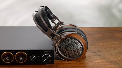 Sivga Egret Planar Magnetic Headphones next to headphone amp