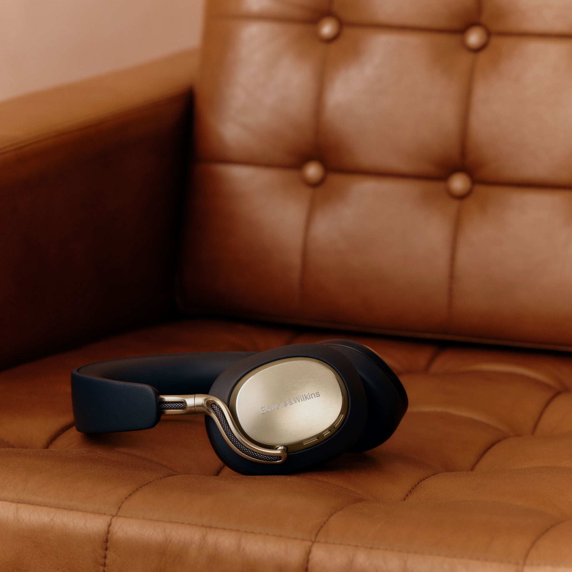 Blue headphones on tan couch