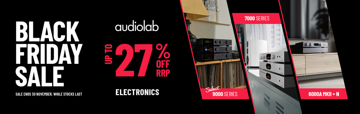 Promotional banner for an audiolab electronics Black Friday Sale, featuring large white and red text on a black background with three inset product photos showing audio equipment in a home or studio setting.