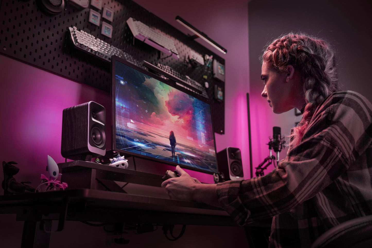 Person using a computer in a dark room with pink lighting
