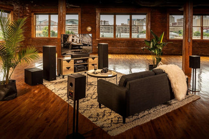 Living room with brown sofa, floor lamps, and large windows.