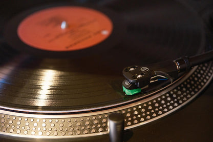 Close-up of a vinyl record on a turntable with a red label.