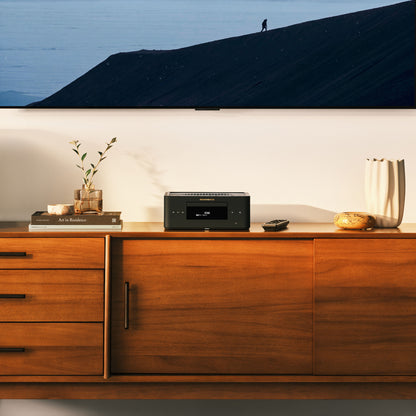 Black Marantz MCR-60N sitting on a timber cabinet with tv screen on wall behind