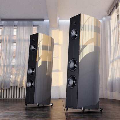 Acoustic Energy Corinium Speakers in midnight silver in front of curtains
