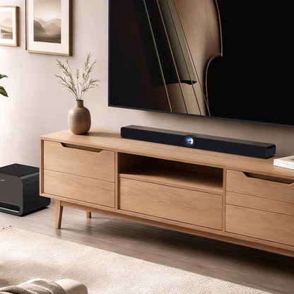 Wooden TV stand with a television, soundbar, and speakers in a living room setting.