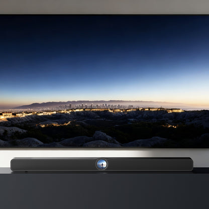 Soundbar below a television displaying a cityscape at dusk.