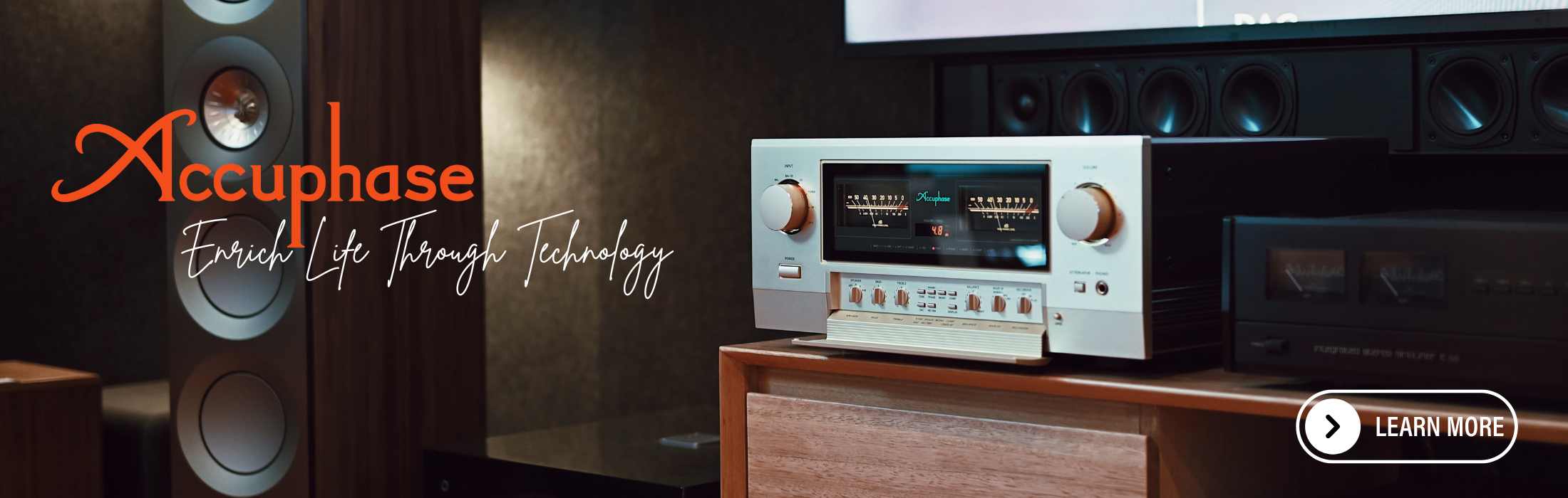 Accuphase audio equipment with speakers and a monitor in a room setting.