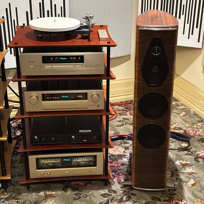 Wooden audio equipment rack with vintage-style audio components and a tall speaker.