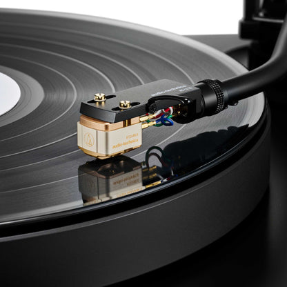 Close-up of a Audio Technica AT33xMLB Moving Coil Cartridge on a vinyl record