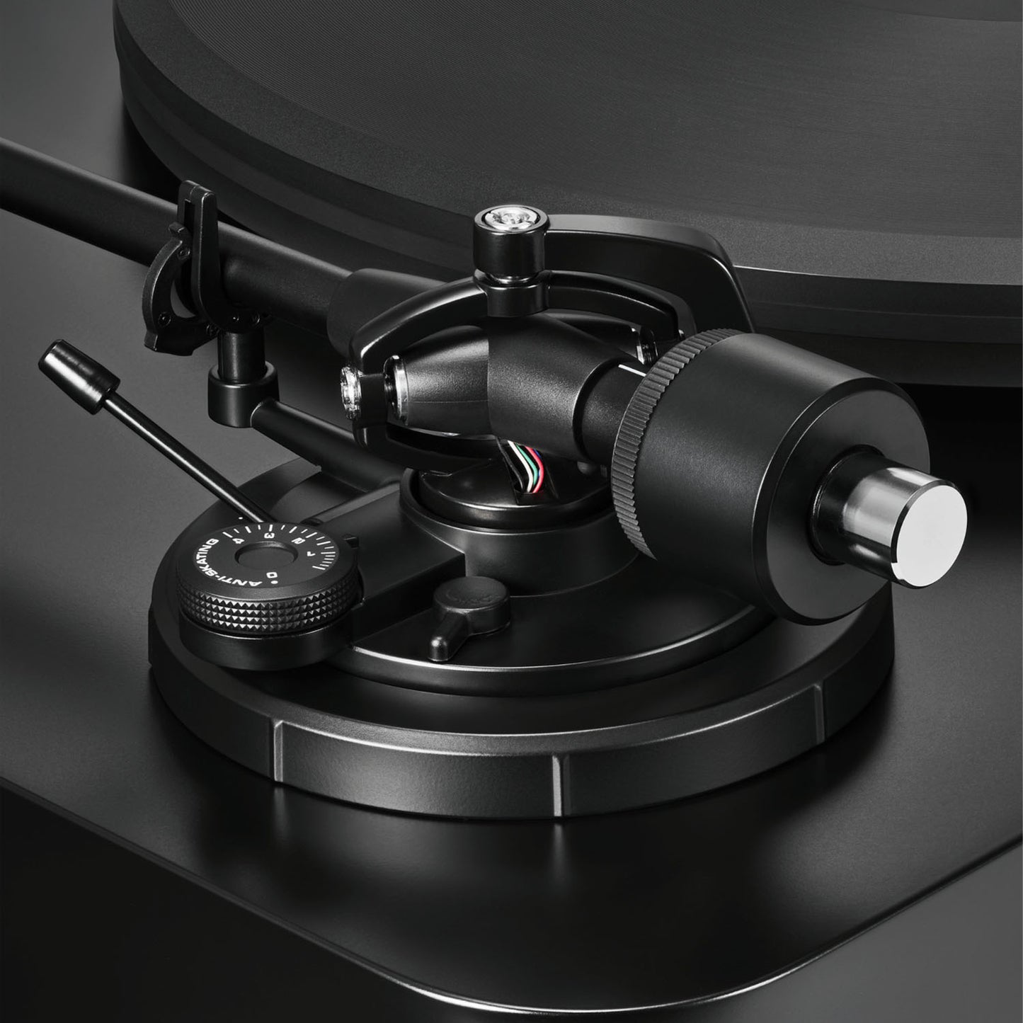 Close-up of a black turntable cartridge on a dark background