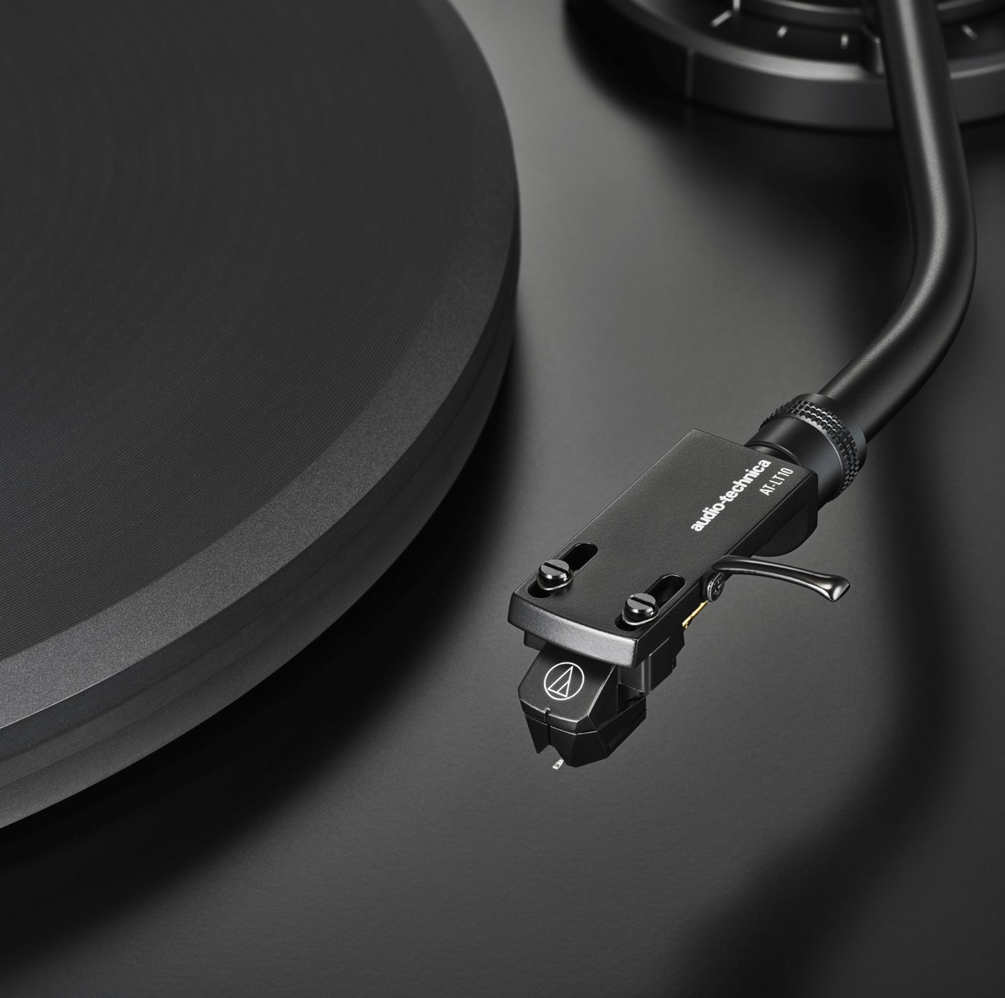 Close-up of a turntable cartridge on a black surface