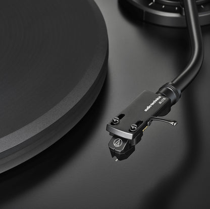 Close-up of a turntable cartridge on a black surface