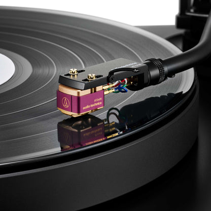Close-up of a Audio Technica AT33xEN Dual Moving Coil Stereo Cartridge on a vinyl record
