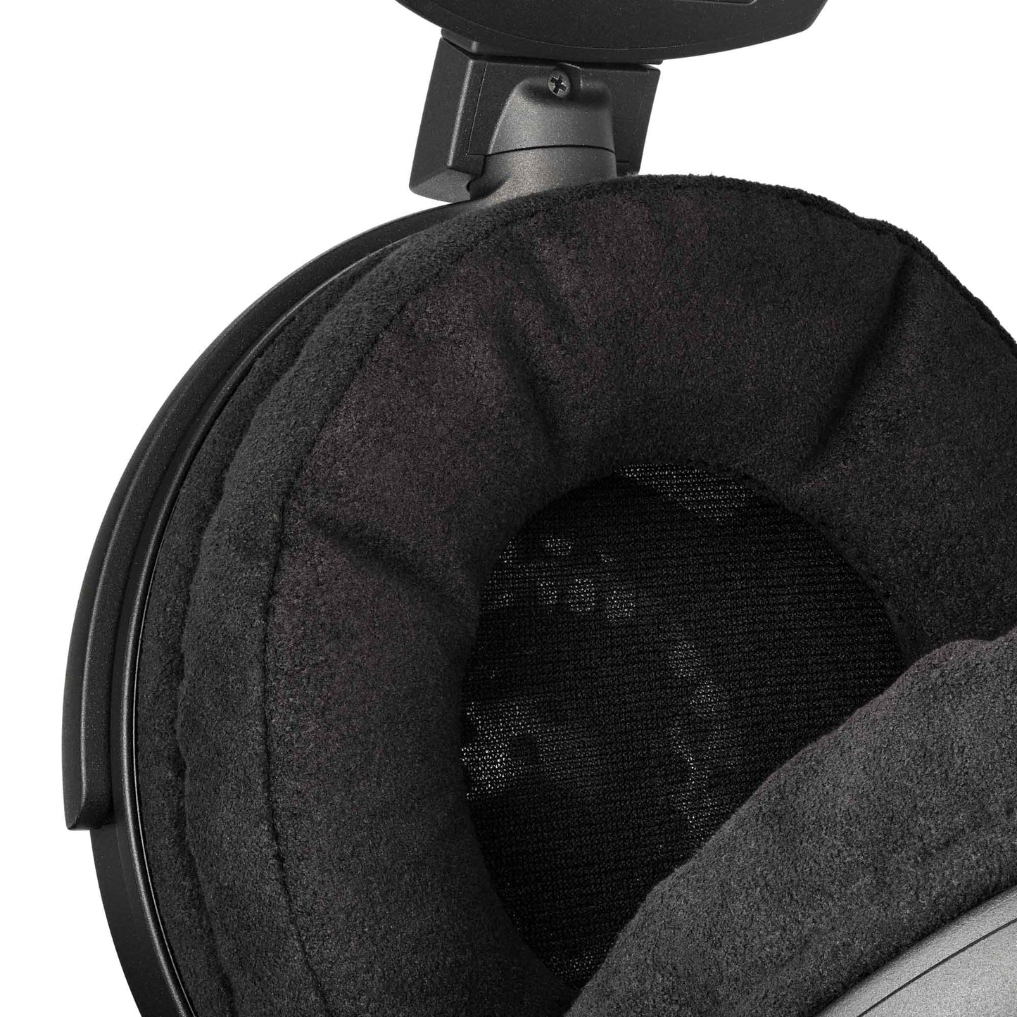 Close-up of a black over-ear headphone with earpads on a white background