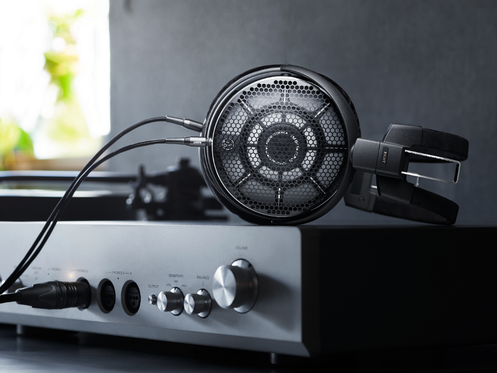 ATH-ADX7000 Headphones connected to an amplifier with a blurred background