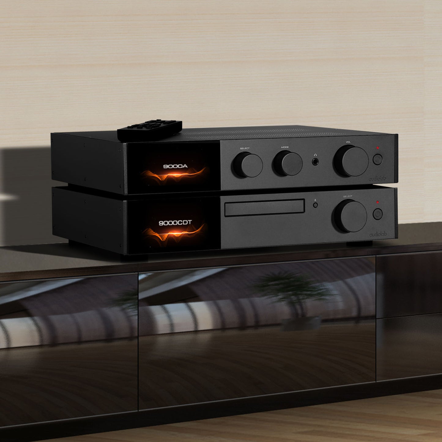 Black audio amplifier and cd player on a reflective surface with a neutral background