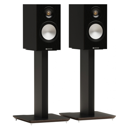 A pair of black bookshelf speakers on matching black floor stands, shown against a plain white background.