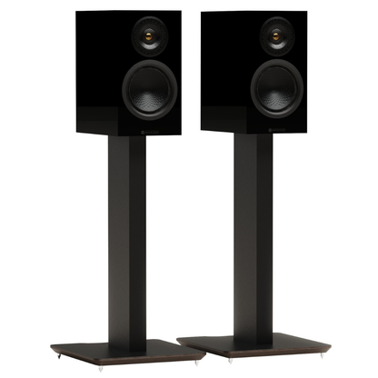 A pair of black bookshelf speakers with dual drivers, mounted on matching black floor stands.