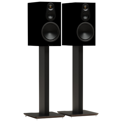 A pair of black bookshelf speakers on matching black floor stands, shown against a solid white background.