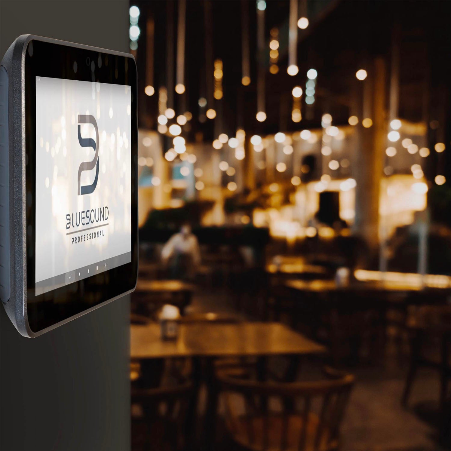 Touchscreen display with Bluesound logo in a restaurant setting