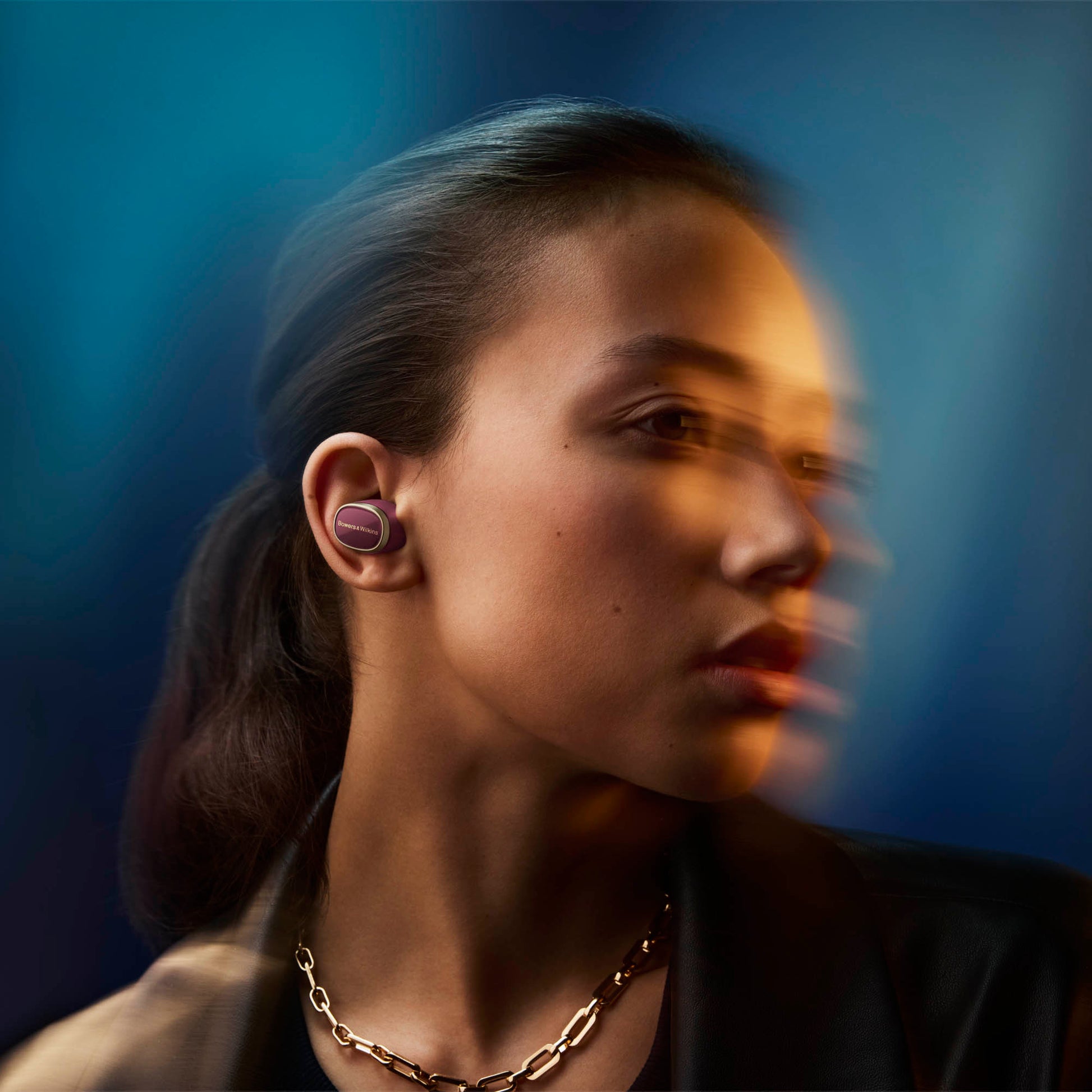 Woman wearing wireless earbuds with a blurred background
