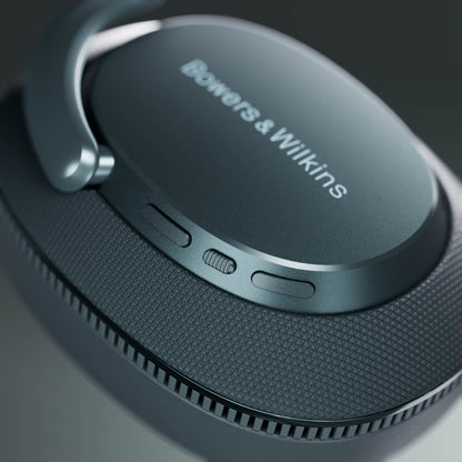 Close-up of a pair of headphones with 'Bowers & Wilkins' branding on a dark background